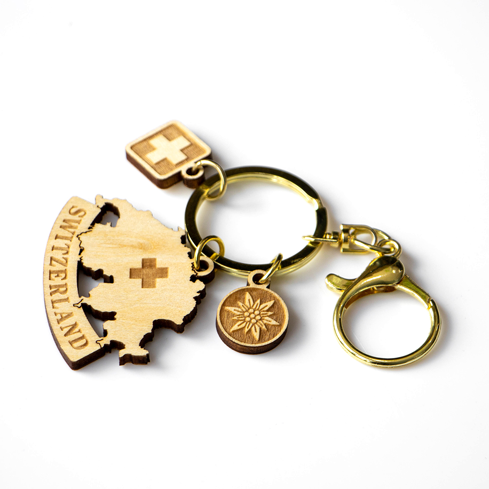 switzerland wooden keychain, swiss map souvenir, alpine flower charm, swiss cross keyring, laser engraved keychain, swiss gift supplier, tourism gifts, custom wooden keychain, switzerland b2b souvenir