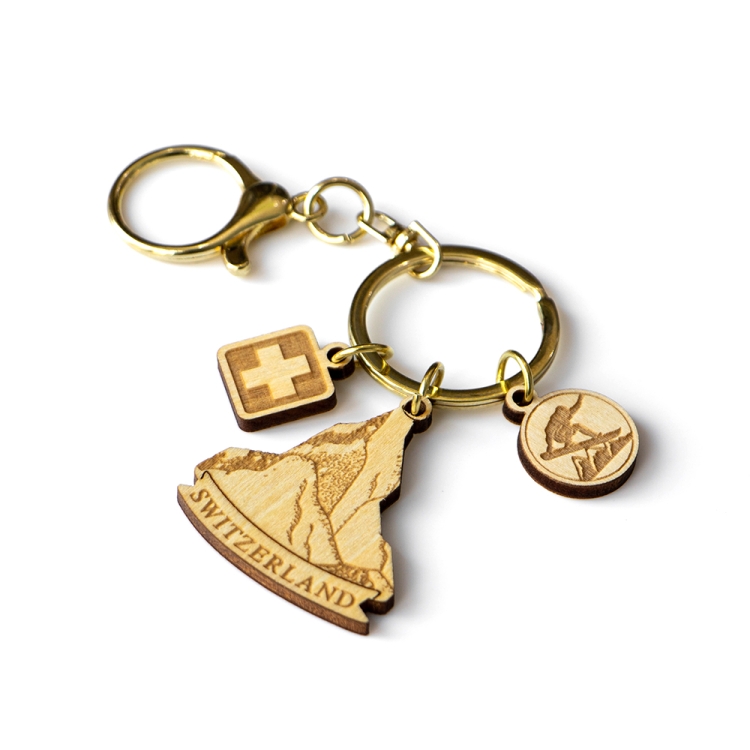 switzerland wooden keychain, swiss alps souvenir, mountain keychain, skiing gift keyring, swiss cross charm, laser cut wood keychain, gold hardware keychain, switzerland b2b gift, custom tourism product