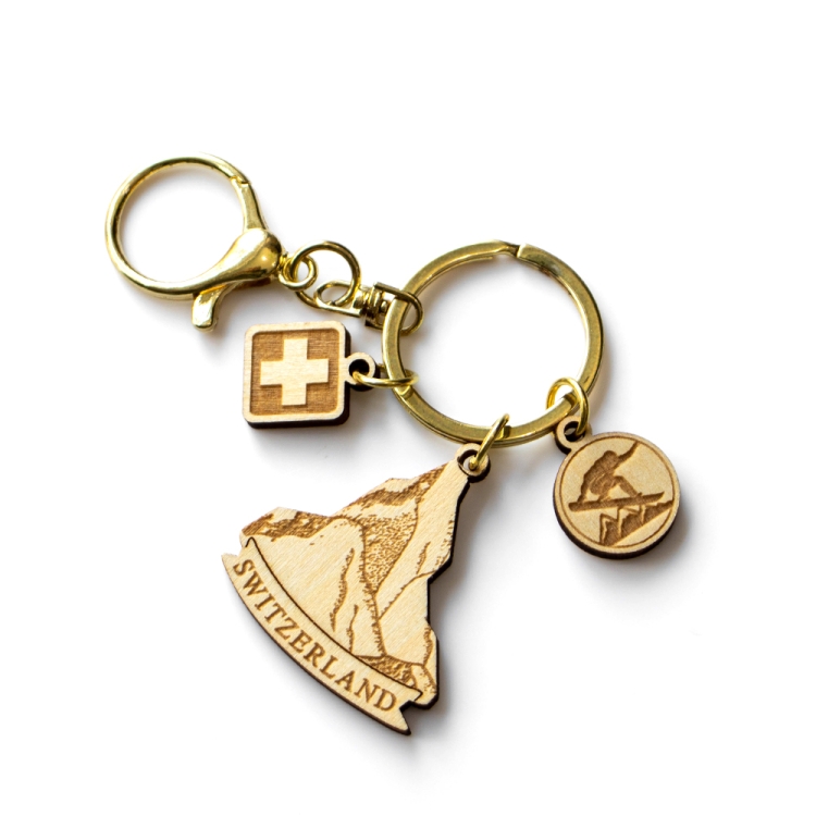 switzerland wooden keychain, swiss alps souvenir, mountain keychain, skiing gift keyring, swiss cross charm, laser cut wood keychain, gold hardware keychain, switzerland b2b gift, custom tourism product